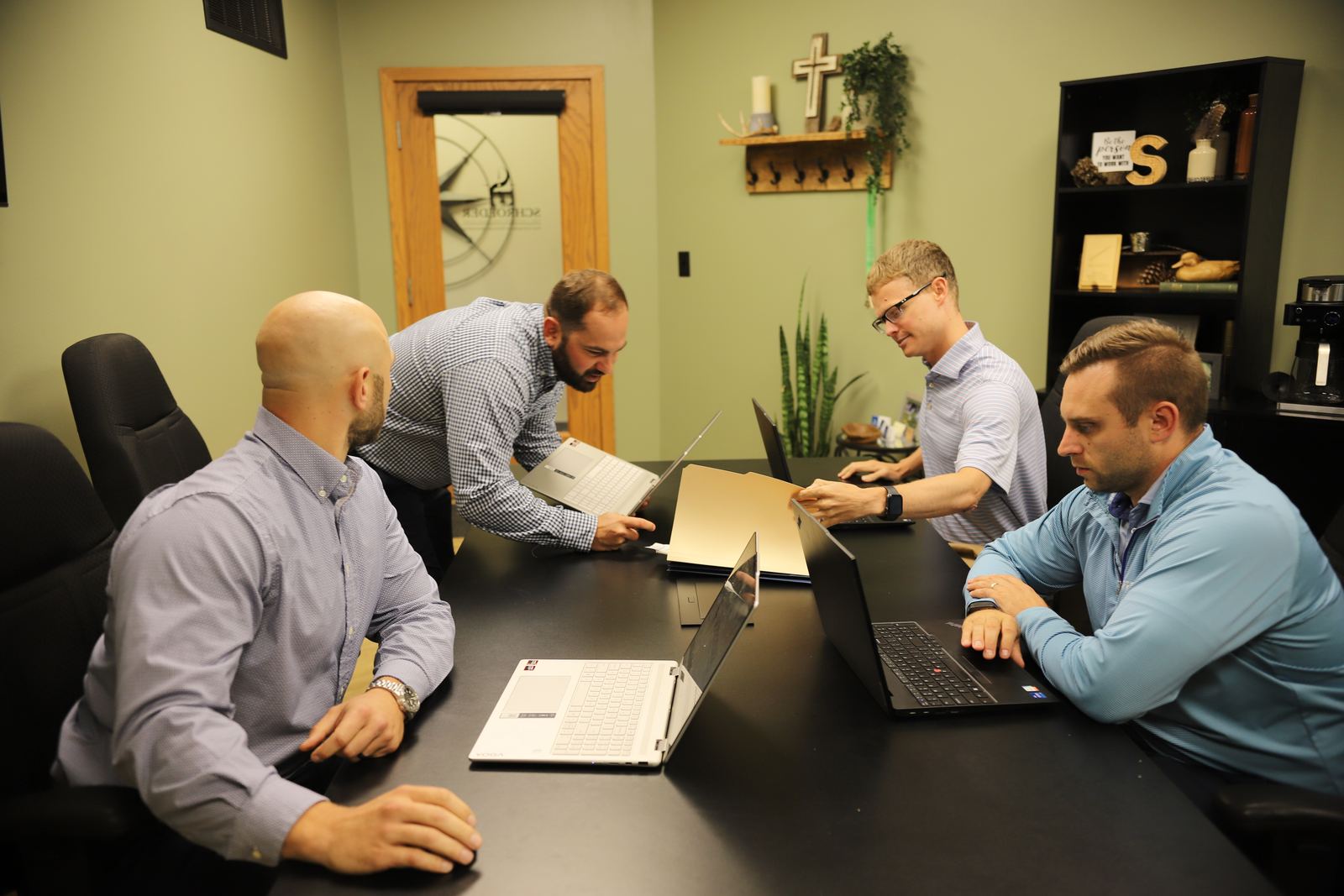 The Schroeder CPA team reviewing financials around the conference table
